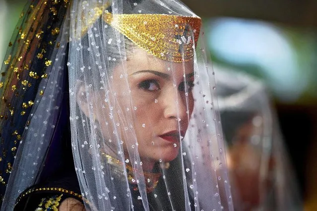 A nymph, a female devotees of the Vale do Amanhecer religious community, prays during their biggest ceremony of the year at their temple complex in Vale do Amanhecer (Sunrise Valley), a community on the outskirts of Planaltina, 50 km from the Brazilian capital, Brasilia, on May 1, 2019. This eclectic community holds its most important ritual of the year on Labour Day to honour the mediums who communicate with good and bad spirits. The group combines a range of religious practices, including Christian and Hindu, with symbols borrowed from the Incas and Mayans, as well as a belief in extraterrestrial life and intergalactic travel. With some 600 temples throughout Brazil, Portugal, Germany, Japan, Bolivia, Uruguay and the United States, the religious movement claims to have 800,000 members. (Photo by Carl De Souza/AFP Photo)