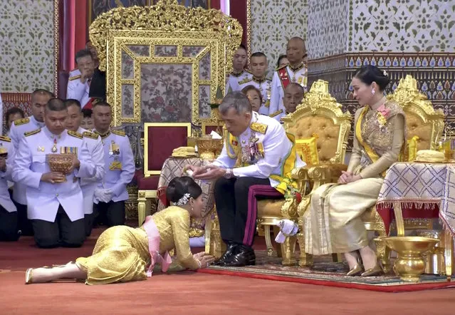 In this image made from video, Thailand’s King Maha Vajiralongkorn, center, and Queen Suthida, right, attend the second of a three-day coronation ceremony for Thai King Maha Vajiralongkorn that includes bestowing of the royal title and granting of ranks to members of royalty at Grand Palace in Bangkok, Sunday, May 5, 2019. Thailand's King Maha Vajiralongkorn was officially crowned Saturday amid the splendor of the country's Grand Palace, taking the central role in an elaborate centuries-old royal ceremony that was last held almost seven decades ago. (Photo by Thai TV Pool via AP Photo)