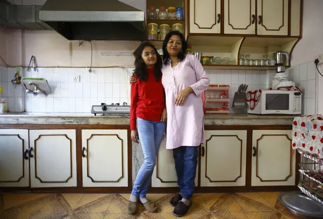 Mohanna Khanal, 35, and her daughter Vipassna Khanal, 12, pose for a photograph in the kitchen of their apartment in Kathmandu February 4, 2014. Mohanna is a school teacher who finished her education when she was 20 years old. Mohanna says that when she was a child, she wanted to become a flight attendant. She hopes that her daughter will become a renowned media personality. Vipassna says that she will finish her education in 2025 and she wants to become a travel agent to promote tourism in Nepal. (Photo by Navesh Chitrakar/Reuters)