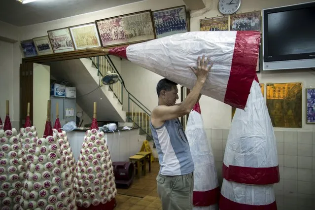 A worker lifts up a small “Bun Mountain”, at Hong Kong's Cheung Chau island, China May 20, 2015, ahead of the upcoming Bun Festival on May 25. (Photo by Tyrone Siu/Reuters)