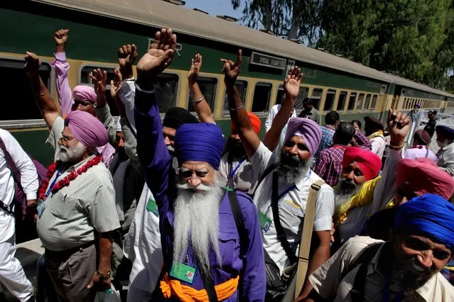 Indian Sikhs wave upon their arrival at the Wagah railway station near Lahore, Pakistan, Tuesday, April 12, 2016. Hundreds of Indian Sikhs arrived in Pakistan for their pilgrimage at the shrine of their spiritual guru. (Photo by K. M. Chaudary/AP Photo)