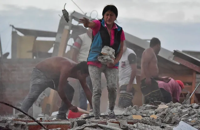 Ecuadorean Veronica Paladines, removes rubble in search for her husband at Tarqui neigbourhood in Manta, Ecuador on April 17, 2016 a day after a powerful quake hit the country. The toll from the big earthquake in Ecuador rose on Sunday to 246 dead and 2,527 people injured, the country's vice president said. (Photo by Luis Acosta/AFP Photo)
