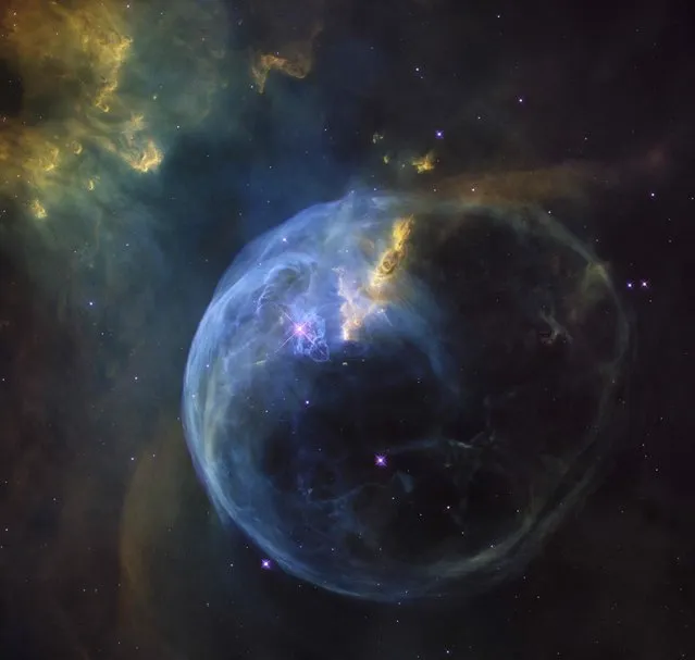 A handout photo released by the European Space Agency shows the Bubble Nebula, also known as NGC 7653, which is an emission nebula located 11 000 light-years away. This stunning new image was observed by the NASA/ESA Hubble Space Telescope to celebrate its 26th year in space. (Photo by AFP Photo/ESA/Hubble)