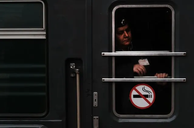 A train conductor looks out of a window as a train pulls into the station in Moscow on March 5, 2017 in Moscow, Russia. (Photo by Spencer Platt/Getty Images)