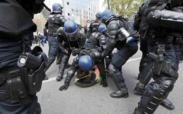 French riot police officers detain a protestor during a demonstration against the French labour law proposal in Lyon, France, as part of a nationwide labor reform protests and strikes, April 28, 2016. (Photo by Robert Pratta/Reuters)