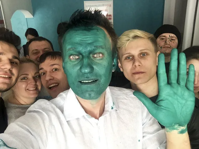 In this handout photo provided by Alexei Navalny, Russian opposition leader Alexei Navalny makes a selfie with his supporters after a stranger splashed a bright green antiseptic on his face in a city of Barnaul, Russia on Monday, March 20, 2017. Opposition leader Alexei Navalny was splashed with a bright green antiseptic by an unknown assailant Monday in the Siberian city of Barnaul where he was opening a campaign office for his bid to become Russian president in 2018 elections. (Photo by Alexei Navalny/Handout photo via AP Photo)
