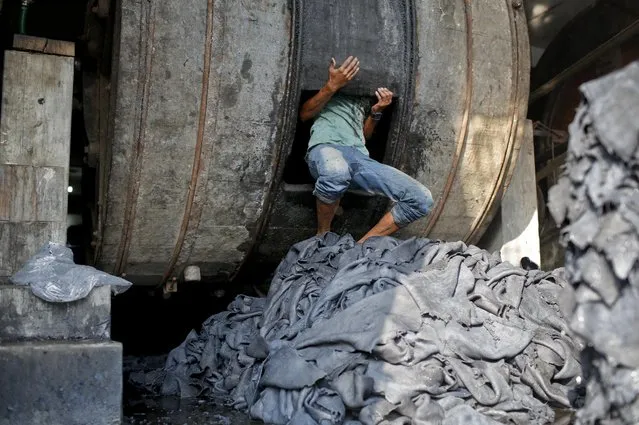 In this February 6, 2017 photo, a Bangladeshi man works inside a tannery factory in the highly polluted Hazaribagh tannery area in Dhaka, Bangladesh. (Photo by A.M. Ahad/AP Photo)