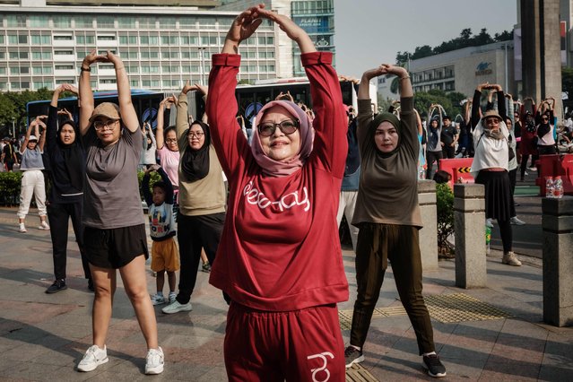 People attend a free morning dance session on the street during a car-free day in Jakarta on May 5, 2024. (Photo by Yasuyoshi Chiba/AFP Photo)