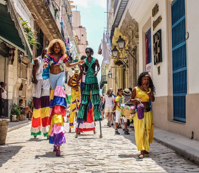 “Stilt walkers in the streets of Havana, Cuba”. (Photo by Eddie Smith/The Guardian)