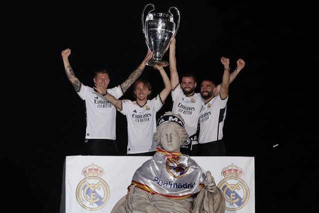 (From L) Real Madrid's German midfielder #08 Toni Kroos, Real Madrid's Croatian midfielder #10 Luka Modric Real Madrid's Spanish defender #06 Nacho Fernandez and Real Madrid's Spanish defender #02 Dani Carvajal celebrate with the trophy their 15th Champions League win, one day after beating Borussia Dortmund in London, on Cibeles square in Madrid on June 2, 2024. (Photo by Thomas Coex/AFP Photo)