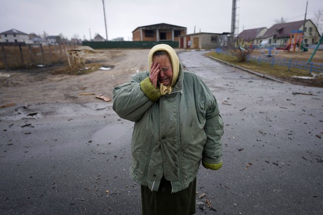 A woman cries outside houses damaged by a Russian airstrike, according to locals, in Gorenka, outside the capital Kyiv, Ukraine, Wednesday, March 2, 2022. Russia renewed its assault on Ukraine's second-largest city in a pounding that lit up the skyline with balls of fire over populated areas, even as both sides said they were ready to resume talks aimed at stopping the new devastating war in Europe. (Photo by Vadim Ghirda/AP Photo)