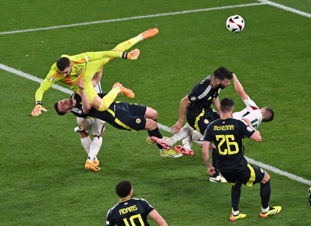 Scotland's Angus Gunn, Anthony Ralston and Hungary's Barnabas Varga collide during their Euro match in Stuttgart, Germany on June 23, 2024. (Photo by Angelika Warmuth/Reuters)