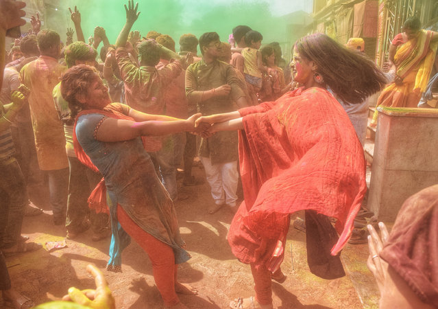 Women dance and play with colorful powders during the Holi festival in Howrah, India on March 7, 2023. Holi is a popular Hindu festival filled with so much fun and is celebrated to mark the beginning of spring season. (Photo by Tamal Shee/SOPA Images/Rex Features/Shutterstock)