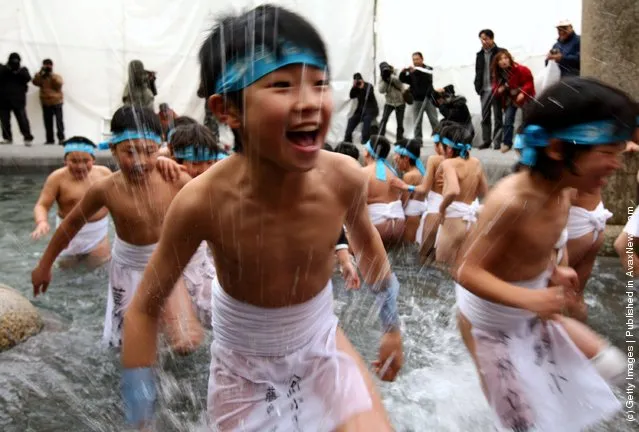 Japanese children wear loincloths as they splash about in freezing cold water during Saidaiji Naked Festival, at Saidaiji Temple