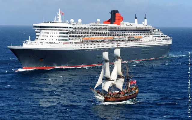 The Queen Mary 2 is saluted by the HMB Endeavour, the replica of Captain James Cook's ship off the coast of Victoria, Australia