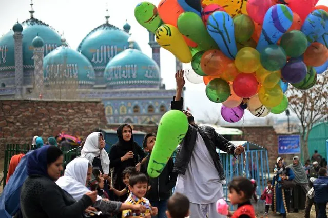 An Afghan vendor sells balloons during the Nowruz festivities to mark the Afghan New Year in Kabul on March 21, 2015. Nowruz, one of the biggest festivals of the war-scarred nation, marks the first day of spring and the beginning of the year in the Persian calendar. Nowruz is calculated according to a solar calendar, this coming year marking 1394. (Photo by Wakil Kohsar/AFP Photo)