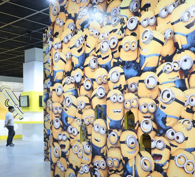 A visitor looks at articles on display for the first Minions exhibition at a gallery in Seoul, South Korea, 21 October 2019, the eve of it​s opening. The special exhibition is to run till 15 March 2020. (Photo by EPA/EFE/Yonhap)