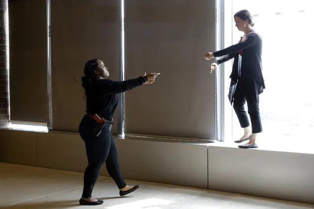 In this September 2, 2015 file photo, Sgt. Cecilia Luckie, left, talks actress Erin Shields, off a ledge during a Crisis Intervention Training class at the New York Police Department Police Academy, in New York. Even before an October 2016 encounter between a schizophrenic woman and a police sergeant left her dead and him now facing a murder charge, NYPD officials realized the need for officers to better understand how to manage mental illness, and created a specialized training. (Photo by Mary Altaffer/AP Photo)