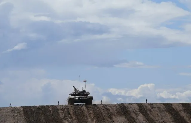 A tank drives on the course of the Tank Biathlon competition during an opening ceremony of the International Army Games-2015 in Alabino, outside Moscow, Russia, August 1, 2015. (Photo by Maxim Shemetov/Reuters)