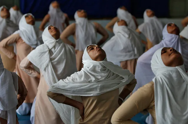 Muslim girls attend a yoga lesson at a school ahead of International Yoga Day in Ahmedabad, India, June 15, 2017. (Photo by Amit Dave/Reuters)