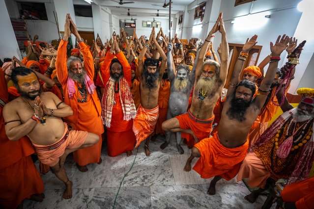 Hindu holy men perform yoga before media on International Day of Yoga at the Kamakhya temple in Guwahati, Assam, India, Wednesday, June 21, 2023. The holy men from different parts of this north eastern state have arrived at the temple to attend the Ambubachi festival that starts from Thursday. (Photo by Anupam Nath/AP Photo)