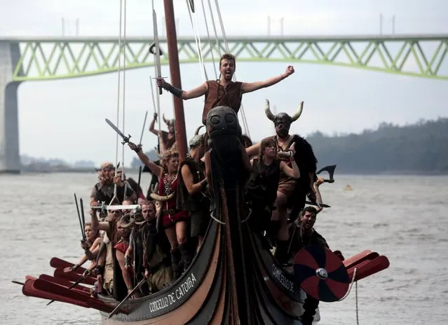 People dressed as Vikings sail on a boat during the annual Viking festival of Catoira in north-western Spain August 2, 2015. (Photo by Miguel Vidal/Reuters)