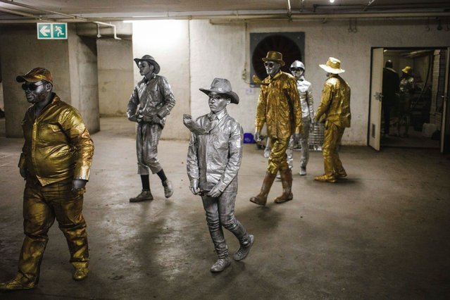 Members of Gold and Silver Nation street artists leave their preparation room in the parking garage of a shopping mall prior to performing at the Rosebank Shopping Mall, Johannesburg, South Africa on June 17, 2023. The group was formed in 2001 and has been performing periodically since then. Hailing from the nearby poor Alexandra Township they take the short taxi trip to the rich area of Rosebank on Saturdays to collect money shoppers will donate. (Photo by Kim Ludbrook/EPA/EFE)