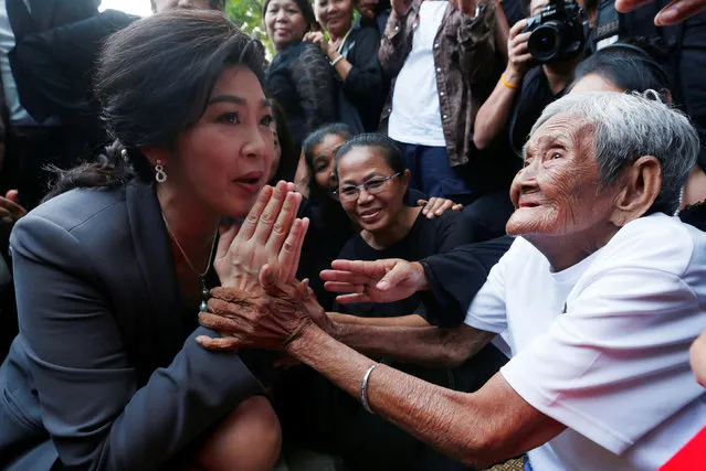 Ousted former Thai Prime Minister Yingluck Shinawatra greets supporters as she arrives at the Supreme Court for a trial on criminal negligence, which looks into her role in a debt-ridden rice subsidy scheme during her administration, in Bangkok, Thailand July 7, 2017. (Photo by Chaiwat Subprasom/Reuters)