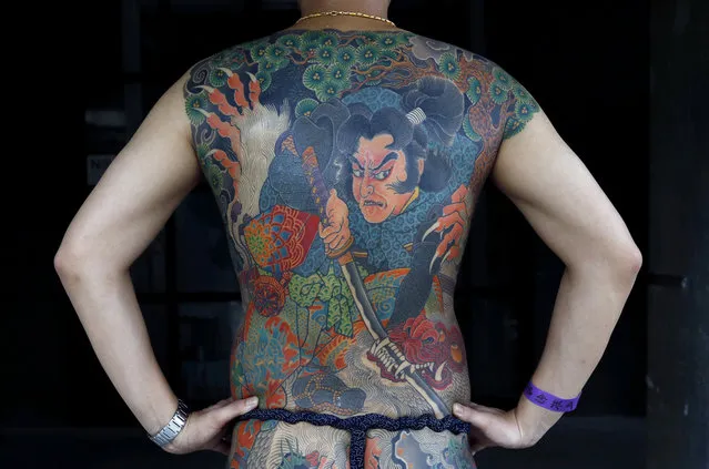 A man poses with his tattoo at Taipei International Tattoo & Music Festival in Taipei, Taiwan July 9, 2017. (Photo by Tyrone Siu/Reuters)