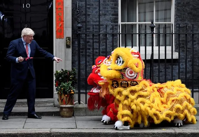 British Prime Minister Boris Johnson gestures as he watches a performance during celebrations for Lunar New Year at Downing Street in London, January 24, 2020. (Photo by Toby Melville/Reuters)