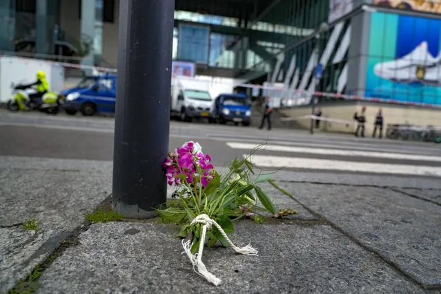 A bunch of flowers lies in front of the Field's shopping center in Copenhagen, Denmark, Monday, July 4, 2022. Danish police believe a shopping mall shooting that left three people dead and four others seriously wounded was not terror-related. They said Monday that the gunman acted alone and appears to have selected his victims at random. (Photo by Sergei Grits/AP Photo)