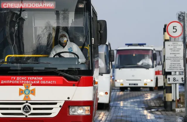 Buses transport Ukrainians and other nationals, who were evacuated from China hit by an outbreak of the novel coronavirus, upon their arrival at an airport in Kharkiv, Ukraine on February 20, 2020. (Photo by Valentyn Ogirenko/Reuters)