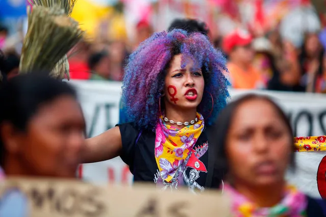 A member of the Landless Workers Movement (MST) shouts slogans calling for gender equality during a march on International Women's Day in Brasilia, on March 8, 2020. Protests, strikes and studies – people around the globe are taking action to mark International Women's Day and to push for action to to obtain equality. (Photo by Sergio Lima/AFP Photo)