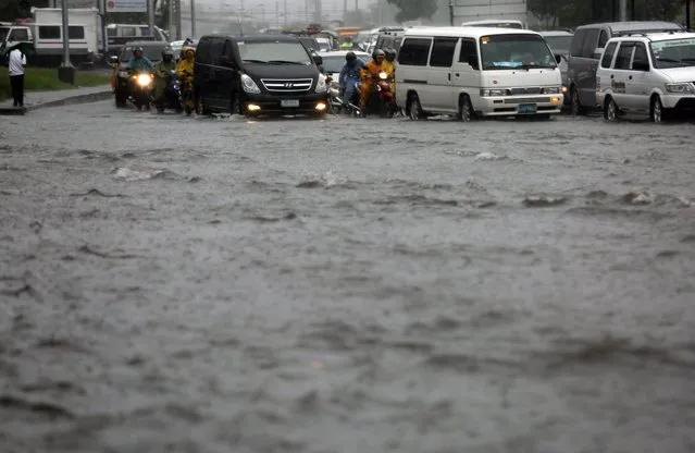 Filipino motorists maneuver on flooded roads during a downpour in Paranaque city, south of Manila, Philippines, 08 July 2016. Typhoon Nepartak brought heavy rains to several areas in Luzon and Metro Manila, work in government offices and school classes were suspended due to flood, and flights were cancelled, according to a National Disaster Risk Reduction and Management Council official. Nepartak was categorized as a super typhoon with 240 kph winds when it hit Taiwan on 08 July. (Photo by Francis R. Malasig/EPA)