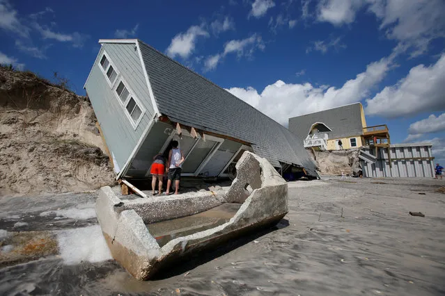 Local residents look inside a collapsed coastal house after Hurricane Irma passed the area in Vilano Beach, Florida, U.S., September 12, 2017. (Photo by Chris Wattie/Reuters)