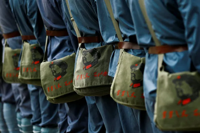 Participants dressed in replica red army uniforms carry bags sporting the portrait of former Chinese leader Mao Zedong during a Communist team-building course extolling the spirit of the Long March, organised by the Revolutionary Tradition College, in the mountains outside Jinggangshan, Jiangxi province, China, September 14, 2017. (Photo by Thomas Peter/Reuters)