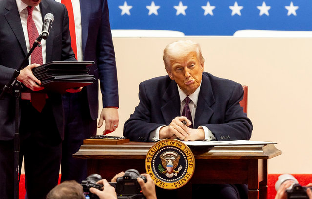 US President Donald Trump signs a series of executive actions on stage during a presidential inaugural event at the Capitol One Arena in Washington, DC, USA, 20 January 2025. Earlier today Trump was sworn in for a second term as president of the United States in the rotunda of the US Capitol, though the ceremonies and events surrounding the presidential inauguration were moved indoors due to extreme cold temperatures. (Photo by Allison Dinner/EPA/EFE)