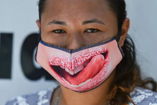 A woman wears a face mask as a preventive measure against the spread of the novel coronavirus COVID-19 at Santa Elena market in Cali, Colombia, on May 15, 2020. (Photo by Luis Robayo/AFP Photo)