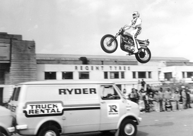 American stuntman Evel Knievel practices jumping over three vans in the parking lot of Wembley Stadium on May 23, 1975. Several days later, Knievel's attempt to jump over 13 buses in front of a crowd inside Wembley Stadium ended in a crash that left him with a broken pelvis. (Photo by Central Press/Getty Images)