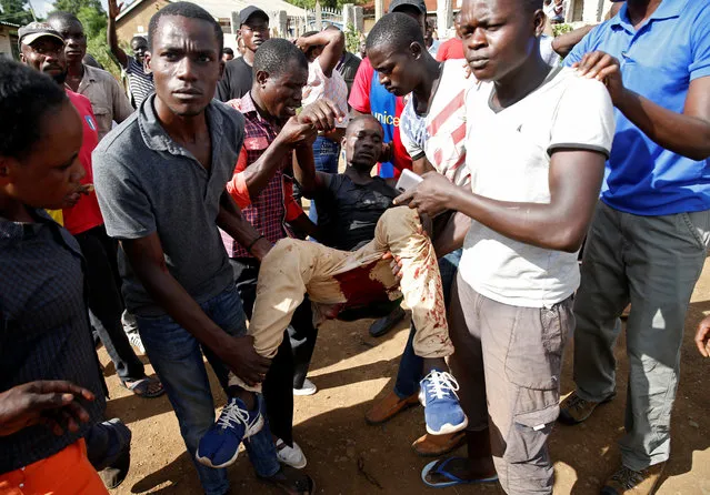 Men carry an injured protester supporting Kenyan opposition leader Raila Odinga, in Kisumu, Kenya on October 26, 2017. (Photo by Baz Ratner/Reuters)