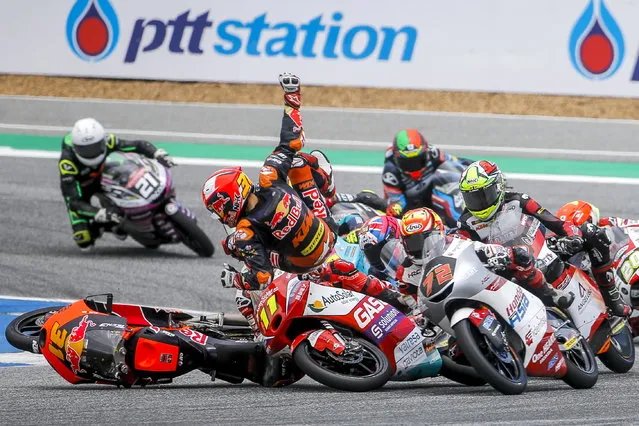 Mexican Moto3 rider Adrian Fernandez of Tech 3 is ejected from his bike as he crashed at the start of the Moto3 race during the Motorcycling Grand Prix of Thailand at Chang International Circuit, Buriram province, Thailand, 02 October 2022. (Photo by Diego Azubel/EPA/EFE)