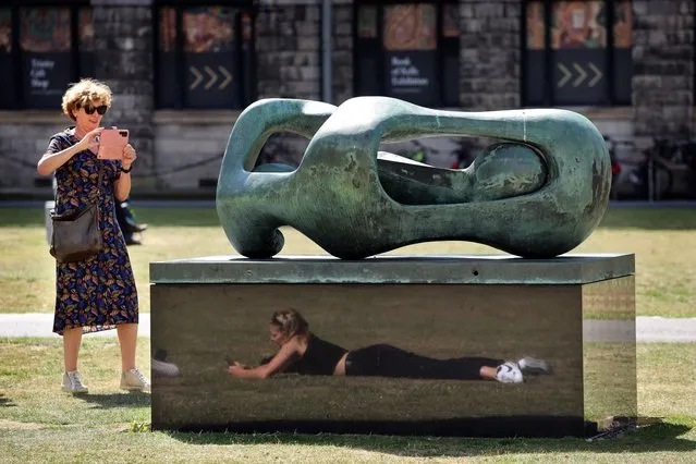 Visitors enjoy the sunshine in Trinity College Dublin on August 30, 2022. (Photo by Dara Mac Dónaill/The Irish Times)