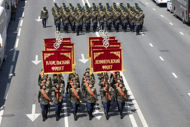 In this file photo taken on Saturday, June 20, 2020, Russian soldiers wearing WWII-era uniforms march toward Red Square to attend a dress rehearsal for the Victory Day military parade in Moscow, Russia. (Photo by Alexander Zemlianichenko/AP Photo/File)