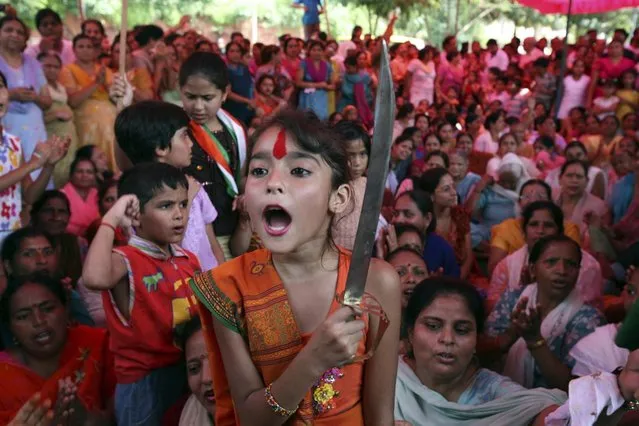 A girl holds a sword during a protest in Jammu August 20, 2008. (Photo by Amit Gupta/Reuters)
