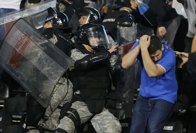 Riot police clashes with fans during the Euro 2016 Group I qualifying soccer match between Serbia and Albania at the FK Partizan stadium in Belgrade October 14, 2014. (Photo by Marko Djurica/Reuters)