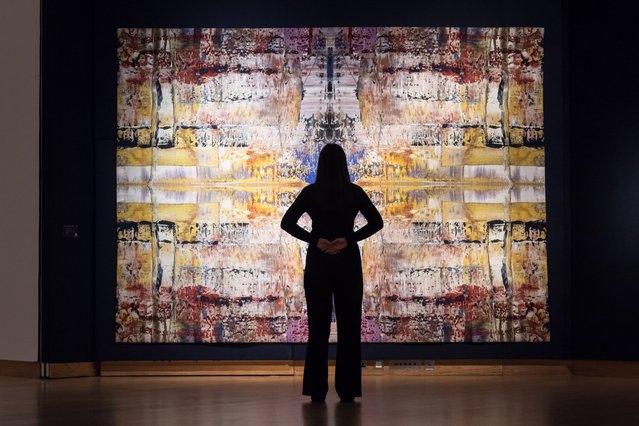A staff member looks at a painting by Gerhard Richter “Abdu”, estimate: £700,000 1,000,000 during a photocall at Christie's auction house ahead of the 20th/21st Century and the Art of the Surreal evening sales in London, United Kingdom on February 27, 2025. (Photo by Wiktor Szymanowicz/Anadolu via Getty Images)