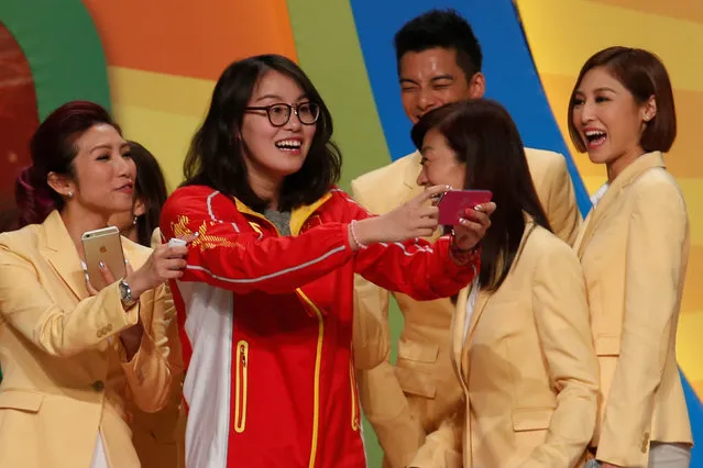 Chinese swimmer Fu Yuanhui takes a selfie with television presenters during an entertainment show by Chinese Rio Olympics medalists in Hong Kong, China August 28, 2016. (Photo by Bobby Yip/Reuters)
