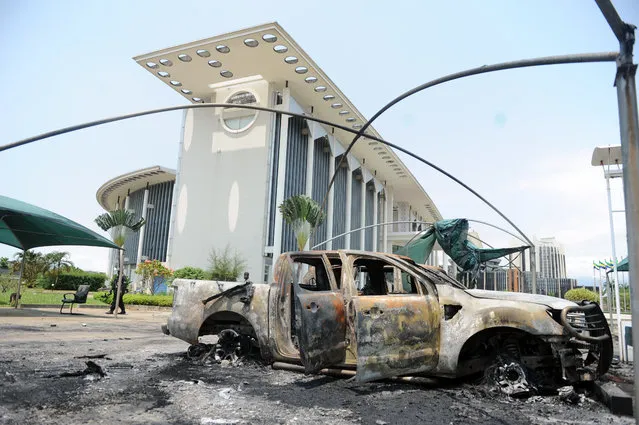 Burnt out cars are seen outside a government building, following an election protest in Libreville, Gabon, Thursday September 1, 2016. Gabon's newly re-elected president sought to assert authority Thursday as the presidential guard attacked the opposition candidate's party headquarters overnight, killing at least one person and injuring more than a dozen amid fiery protests that have seen hundreds detained and the internet blocked. (Photo by Joel Bouopda/AP Photo)