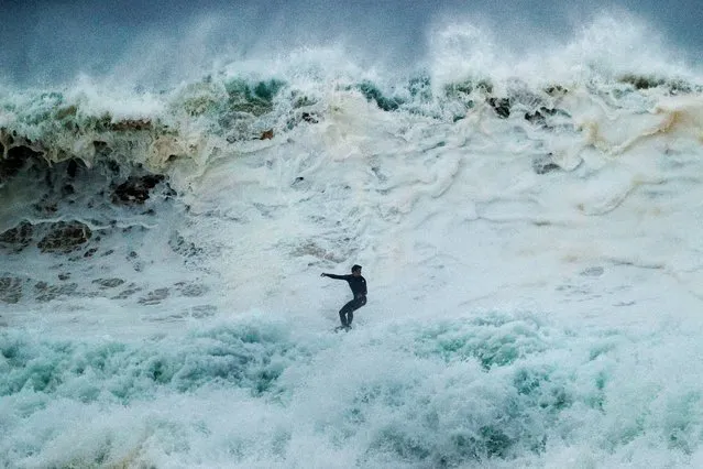 A surfer rides a wave at South Narrabeen on July 27, 2020 in Sydney, Australia. Sydney is bracing for heavy winds and large surf after over 100 millimetres of rain was recorded on Sunday. (Photo by Mark Evans/Getty Images)