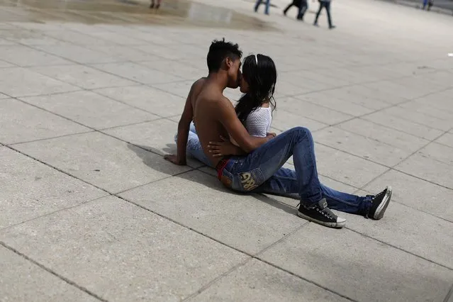 A young couple kiss at a park in Mexico City October 24, 2014. (Photo by Tomas Bravo/Reuters)